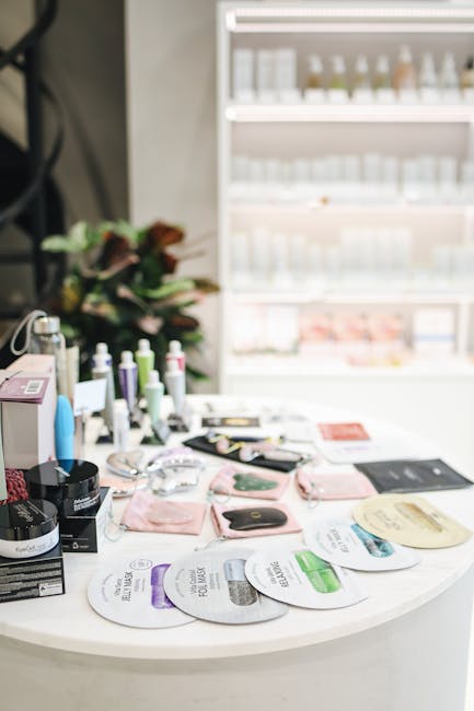 A diverse collection of skincare products neatly arranged on a white counter inside a modern store.